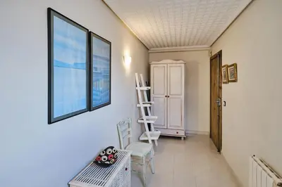 a hallway with chairs and a window and a ladder at Penthouse Inlakesh in Valencia