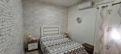 a bedroom with a bed and a flat screen tv at Habitación San Cayetano in Valencia
