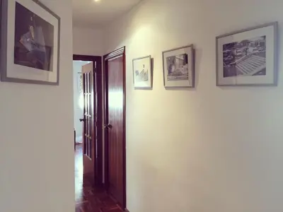 a hallway with three pictures on the walls at Rio Turia Skatehouse in Valencia