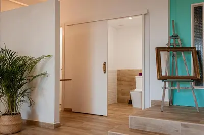 a room with a door and a mirror and a plant at Villa Entrenaranjos in Picassent