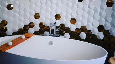 a bath tub in a bathroom with geometric tiles at Hexagonal Design Apartment in Valencia