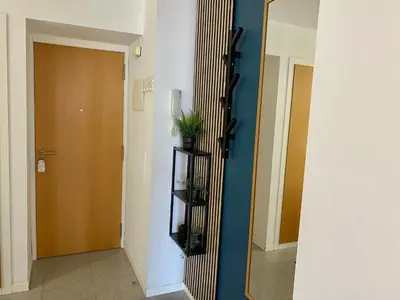 a hallway with a door and a shelf with plants at Acogedor Apartamento in Valencia