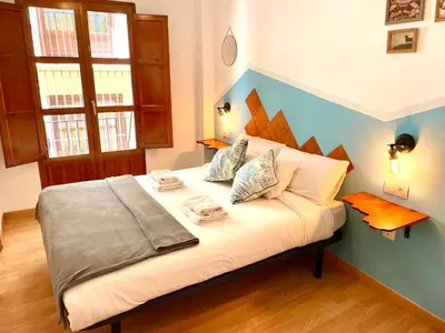a bedroom with a bed with white sheets and pillows at Catedral Apartments in Valencia