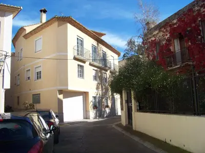 a car parked in front of a building at Apartamentos Chelo in Navajas