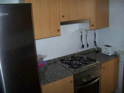 a kitchen with a stove and a toaster oven at Apartamentos Chelo in Navajas