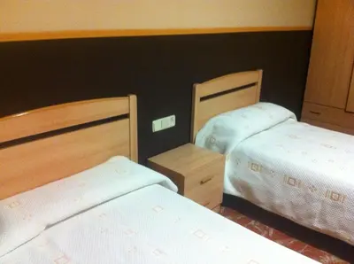 two beds in a hotel room with two beds sidx sidx sidx at Hotel Manises in Manises