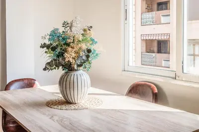 a vase filled with flowers sitting on a table at Casa los Buhos in Valencia