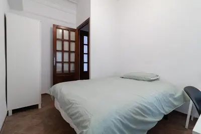 a bedroom with a bed with a pillow on it at La Casa de los Espejos in Valencia