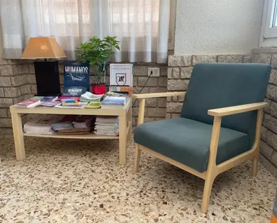 a desk and a chair and a table with books at Hostal Moreno in Silla