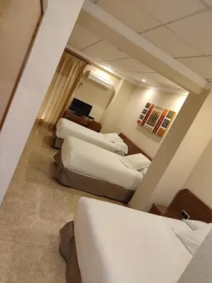 a view of a room with two beds at Hostal Moreno in Silla