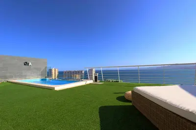 a balcony with a swimming pool and the ocean at Can Lou-Casa con Caracter en Cullera in Faro de Cullera