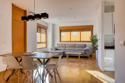 a living room with a table and a couch at Palau de Palomar - PalomarGroup in Valencia