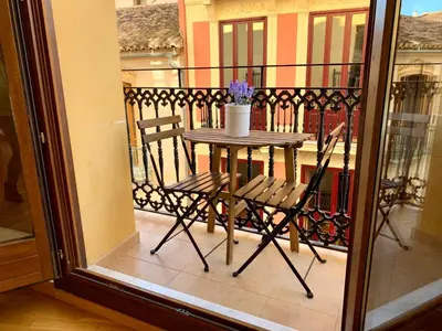 a living room with a table and a couch at Palau de Palomar - PalomarGroup in Valencia