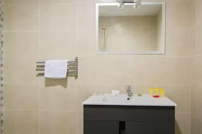 a bathroom with a sink and a mirror at Partenopeo 26 in Valencia