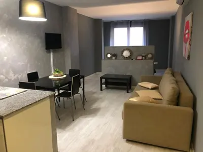 a living room with a couch and a table at Partenopeo 26 in Valencia