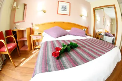 a bedroom with a bed with a red rose on it at Maria de Luna in Segorbe