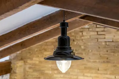 a black light hanging from a wooden ceiling at ANELSA Apmts DESCUBRE VALENCIA Y SU PLAYA in Valencia
