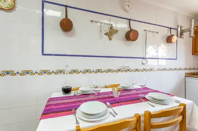 a table with plates and wine glasses on it at Casa Rural Garza in Pedralba