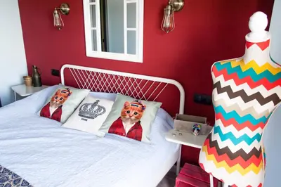 a bedroom with a bed with two dogs on pillows at Sea view Port Saplaya Apartments,2 in Port Saplaya