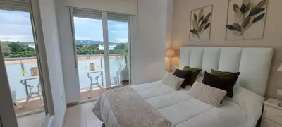 a bedroom with a white bed and a balcony at Apartamento Romero Valencia in Benicull