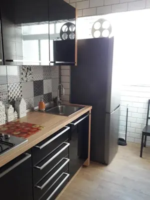a kitchen with a sink and a refrigerator at Carrer Roma in Sagunto