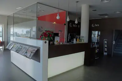 a restaurant with a counter with a newspaper on it at Hotel AS Torrent in Torrent