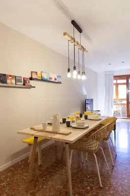 a dining room table with chairs and a wooden tableablish at FLORIT FLATS - Apartment Torres de Quart I in Valencia