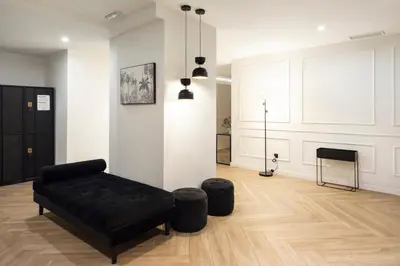 a living room with a black couch and a fireplace at Blanq Comedias in Valencia