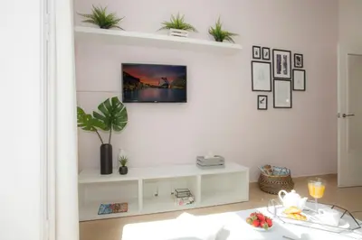 a living room with a white shelf with plants on it at SingularStays Seu Catedral in Valencia