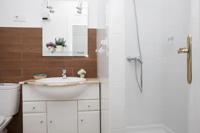 a bathroom with a toilet and a sink and a shower at SingularStays Seu Catedral in Valencia