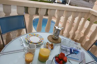 a glass table with a plate of fruit and juice at SingularStays Puzol Beach VII in Puzol