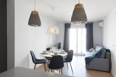 a dining room and living room with a table and chairs at FLORIT FLATS - Apartment Torres de Quart II in Valencia