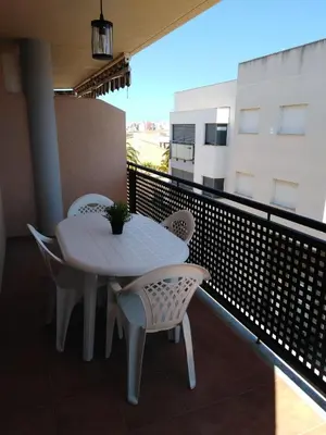 a white table and chairs on a balcony at El apartamento de Marina en Chilches playa in Xilxes