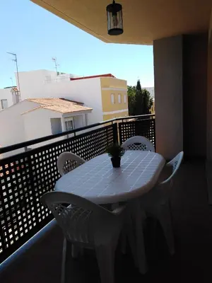 a white table and chairs on a balcony at El apartamento de Marina en Chilches playa in Xilxes
