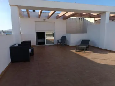 an outdoor patio with two chairs and a table at El apartamento de Marina en Chilches playa in Xilxes