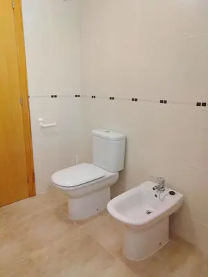 a white bathroom with a toilet and a bidet at El apartamento de Marina en Chilches playa in Xilxes