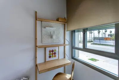a small room with a window and wooden shelves at ApartUP Patacona Select in Valencia