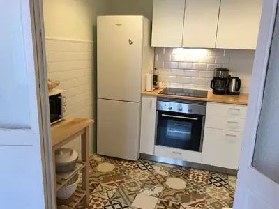 a kitchen with a white refrigerator and a stove at Appartement Elsa Valencia in Valencia