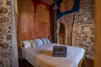 a bedroom with a bed with two towels on it at DOMUS Amabilis in Sagunto