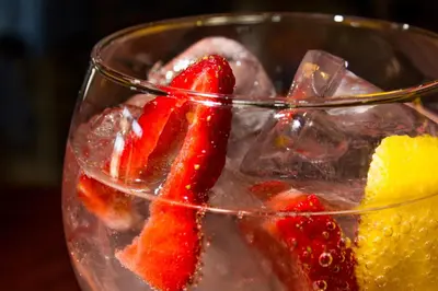 a glass bowl filled with strawberries and other fruit at Hotel-Restaurante Casa Blava Alzira in Alzira