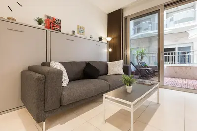 a living room with a couch and a table at PATACONA BEACH VISTAS AL MAR in Valencia