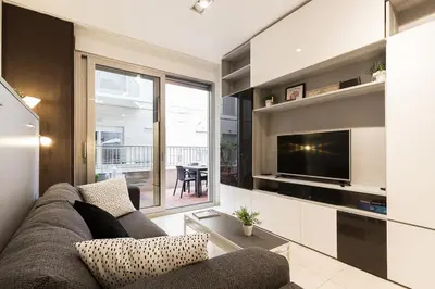 a living room with a couch and a television at PATACONA BEACH VISTAS AL MAR in Valencia
