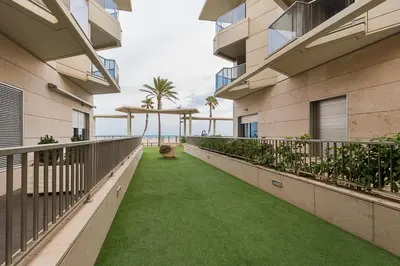 an empty balcony of a building with green grass at PATACONA BEACH VISTAS AL MAR in Valencia