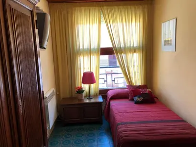 a hotel room with a bed and a window at Casa Rural 