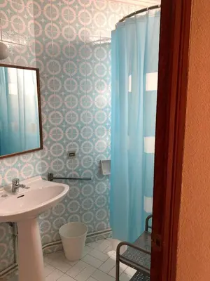 a bathroom with a sink and a shower with a mirror at Casa Rural 