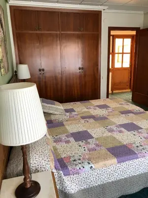 a bedroom with a quilt on a bed with a lamp at Casa Rural 