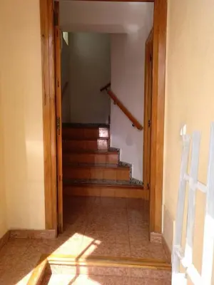 a hallway with a stairway with a door and a stair case at Casa Vall de Almonacid in Vall de Almonacid