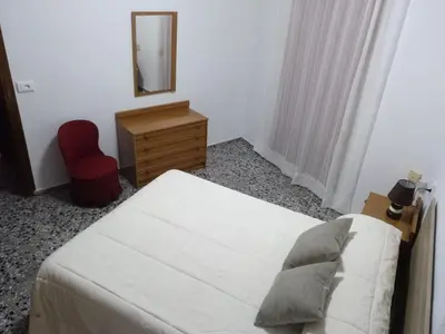 a bedroom with a bed and a dresser and a mirror at Casa Vall de Almonacid in Vall de Almonacid