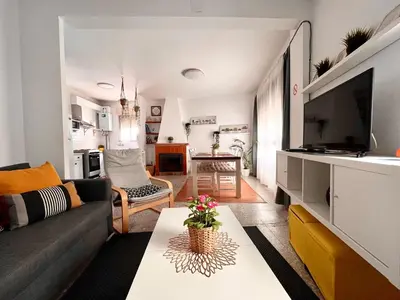 a living room with a couch and a tv at Casa Valle del Turia in Chulilla