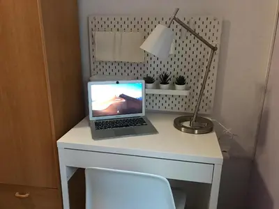 a laptop computer sitting on a white desk with a lamp at Casa Valle del Turia in Chulilla